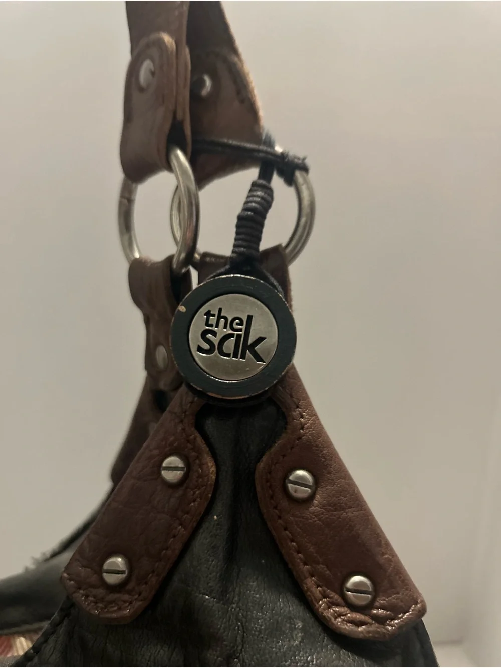 The Sak Black Leather Hobo Bag with Brown Trim